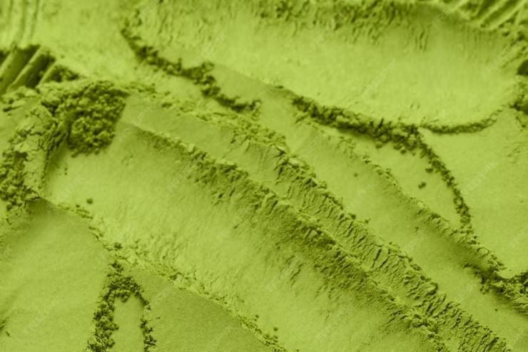 Close-up of green powder with textured surface